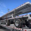 aluminum flatbed trailers stacked sunny day- REITNOUER MAXMISER LOW PROFILE TRAILER
