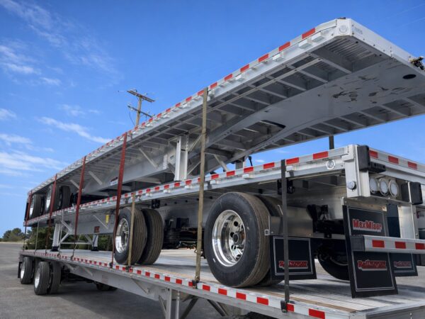 aluminum flatbed trailers stacked sunny day- REITNOUER MAXMISER LOW PROFILE TRAILER