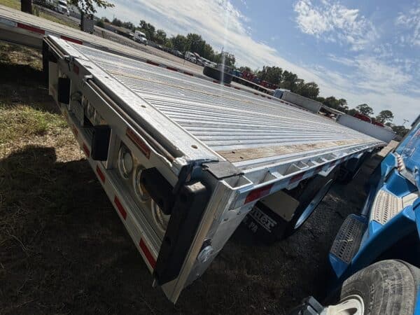 Used 2024 Reitnouer DropMiser step deck with two toolboxes and loading ramps. Unit 65316, priced at $62,500.