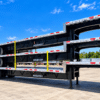 Rear view of three stacked Wabash Combo step deck trailers showing round tail lights, reflective tape and rear bumpers